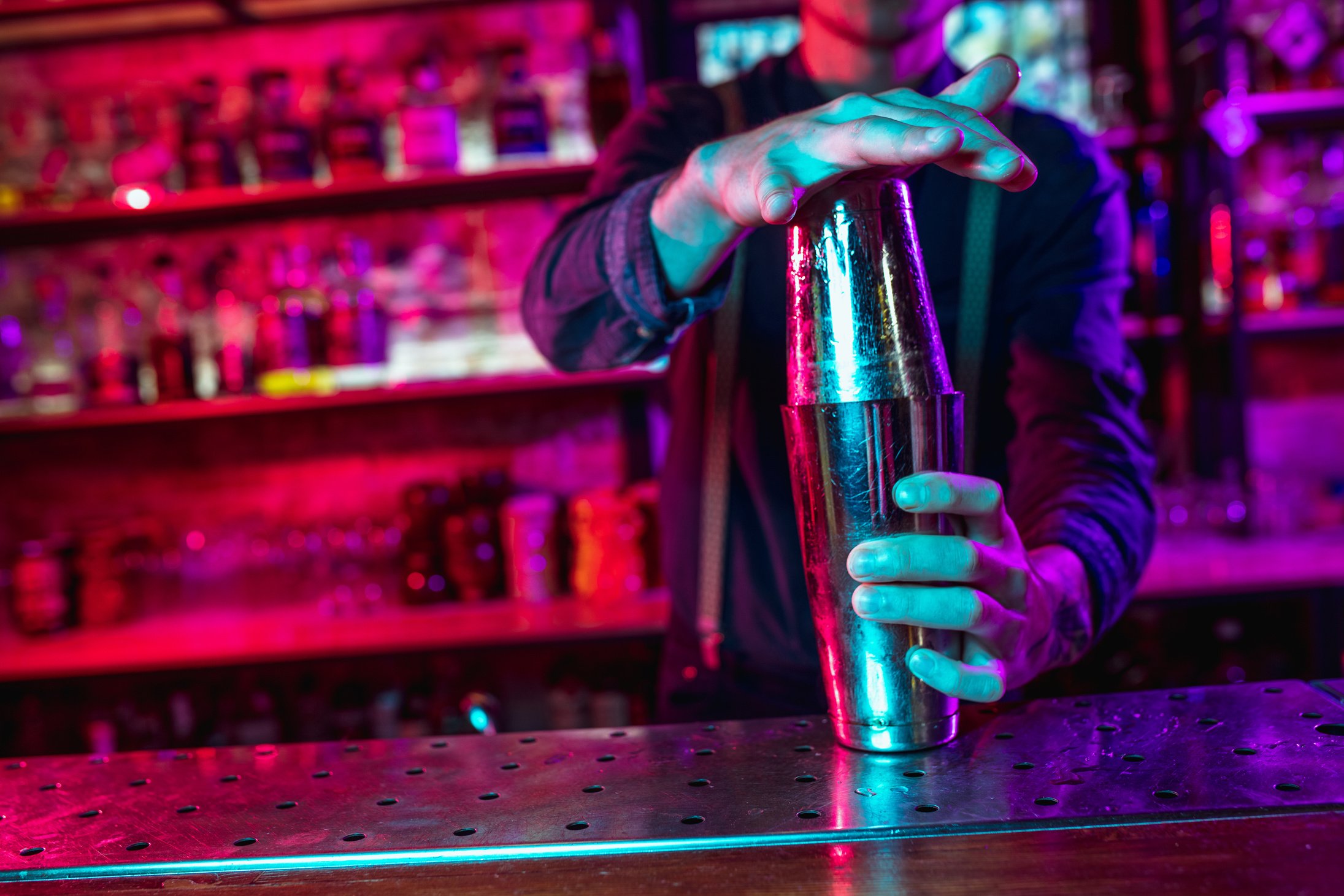 Hand of Bartender Shaking a Cocktail Drink on a Shake